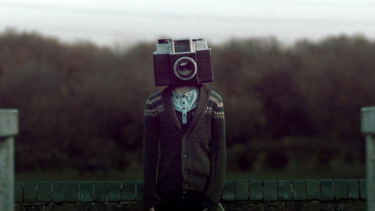 The Boy with a Camera for a Face backdrop